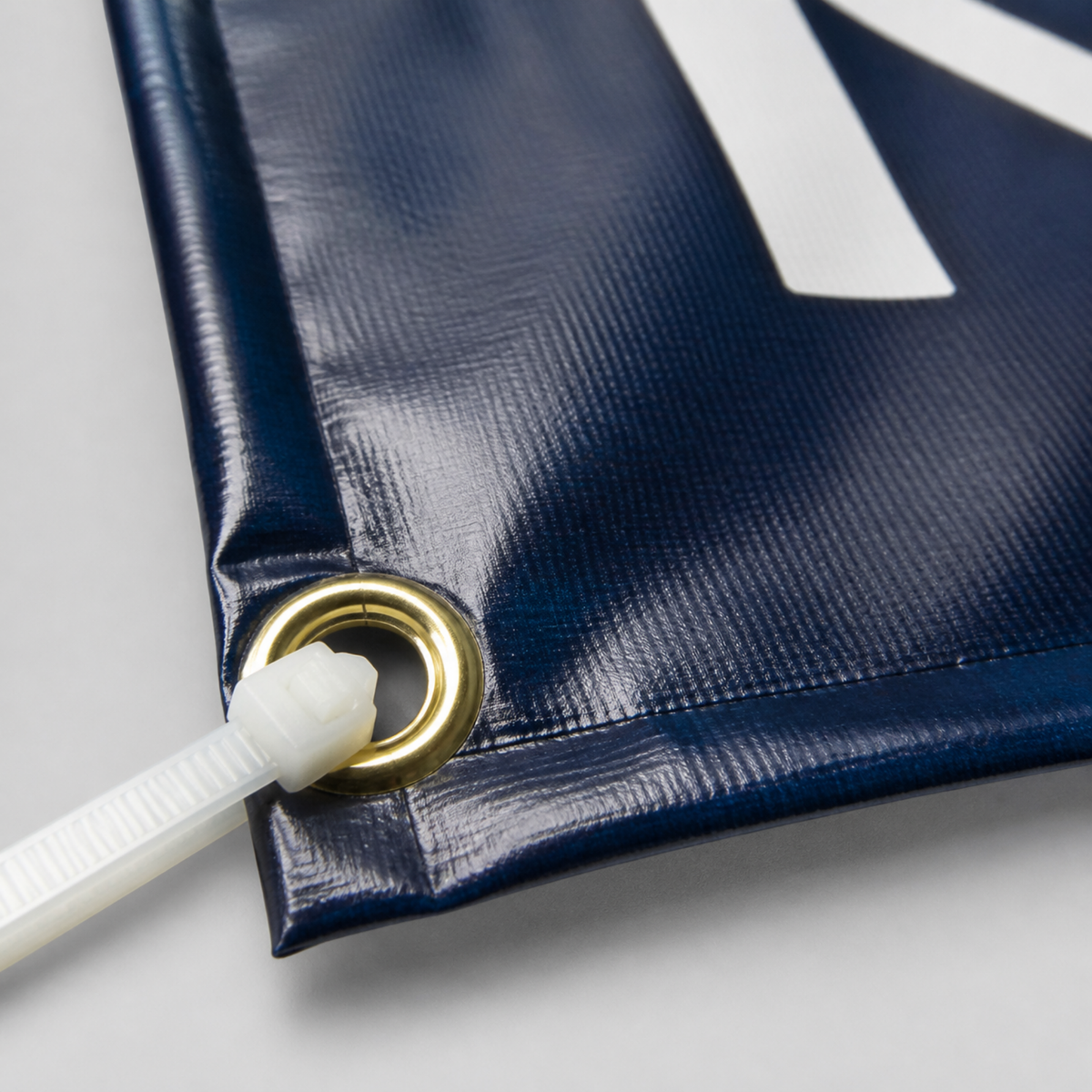 Hemmed edge and metal grommet close-up