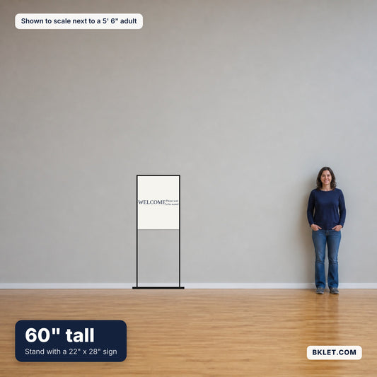 60 inch poster stand with a 22 x 28 inch sign, shown to scale next to an adult
