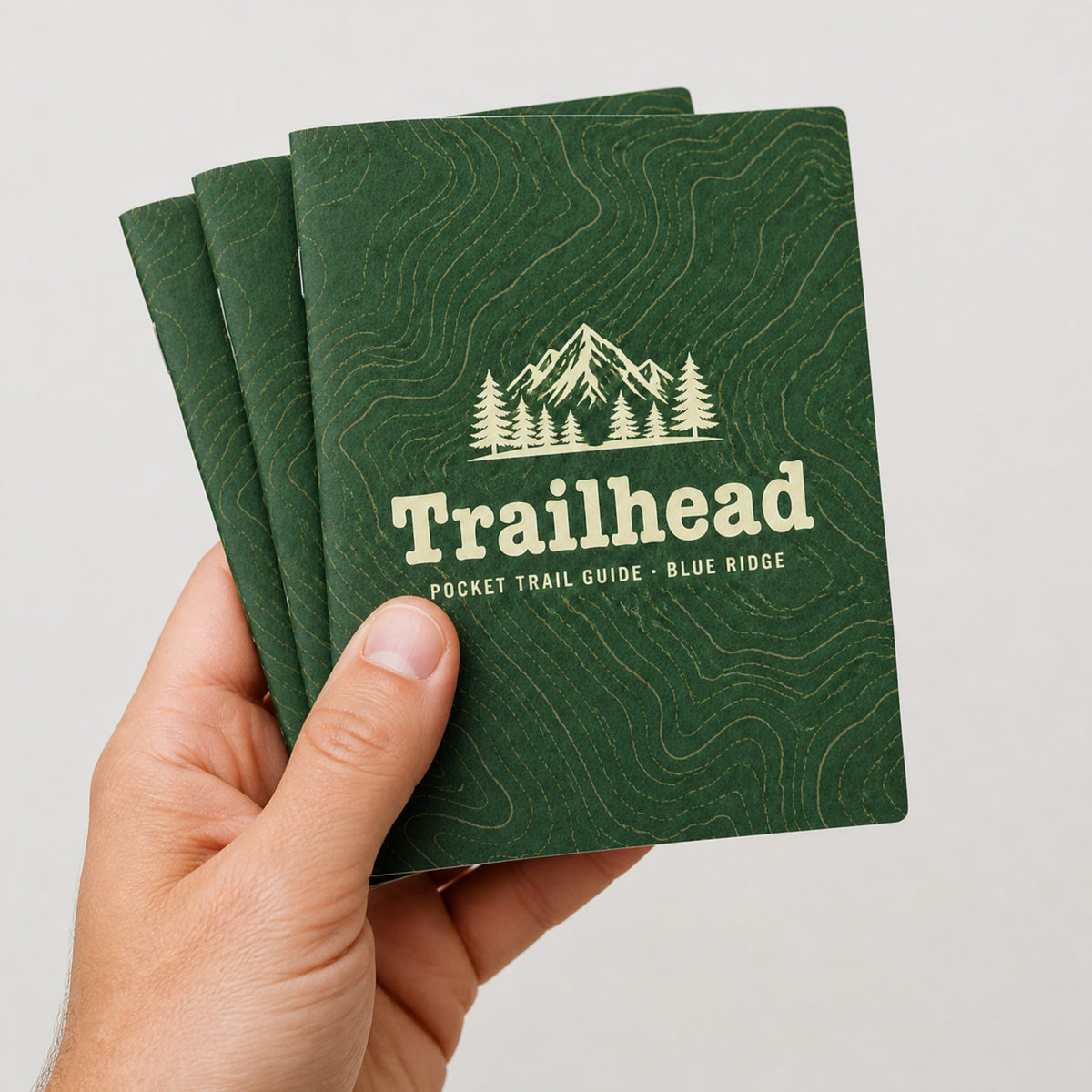 Pocket-size 4.25 x 5.5 all-cardstock trail guides held in hand