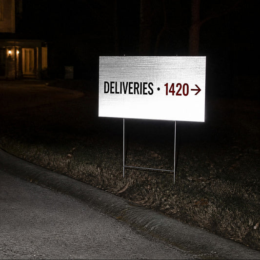 Reflective yard sign glowing in headlights