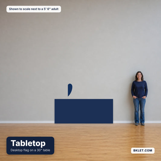 Desktop flag on a 30 inch table, shown to scale next to an adult