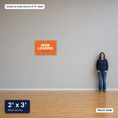 Mesh banner, 2' x 3', shown to scale next to an adult