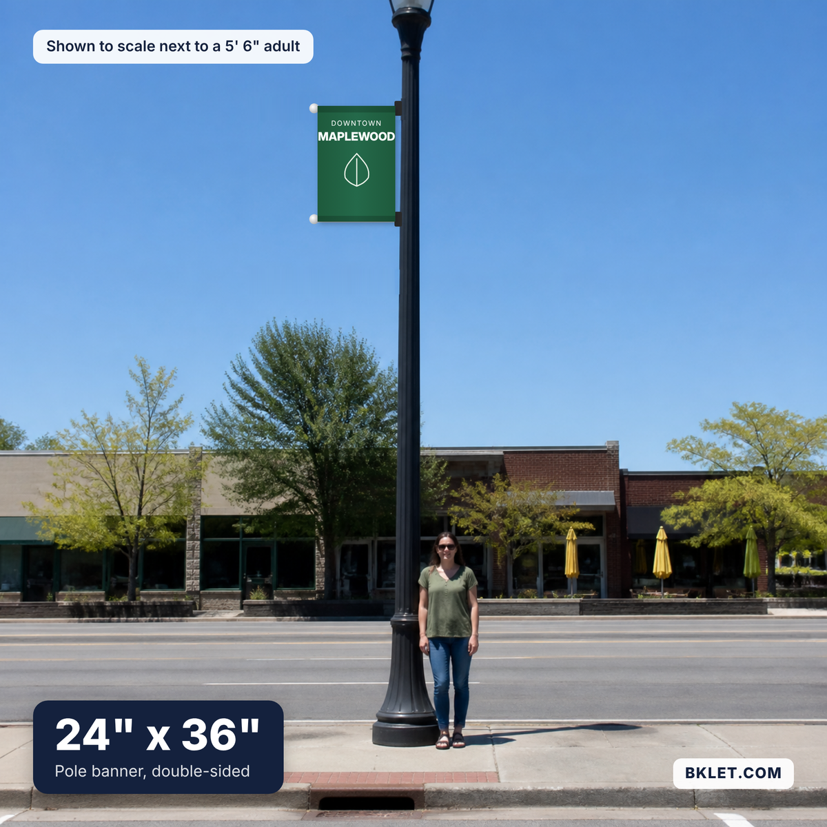 Pole banner, 24" x 36", shown to scale next to an adult
