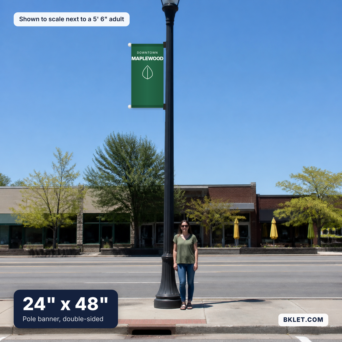 Pole banner, 24" x 48", shown to scale next to an adult