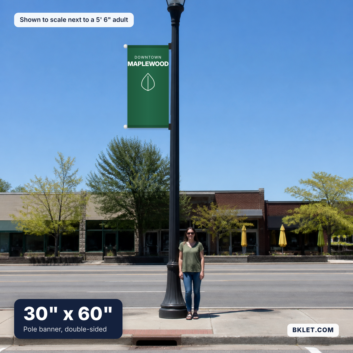 Pole banner, 30" x 60", shown to scale next to an adult