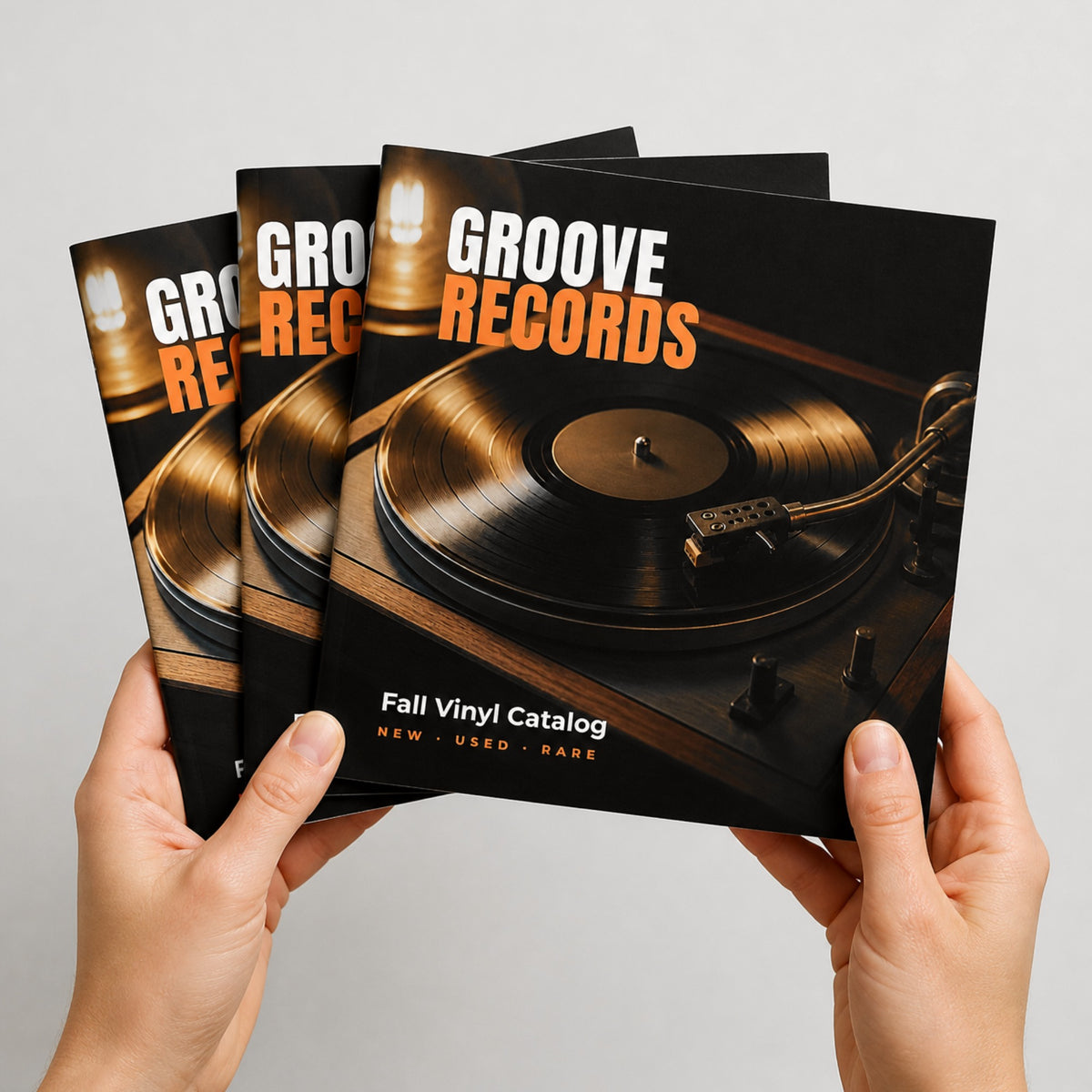 Custom 12 x 12 square saddle-stitched booklets held in hand