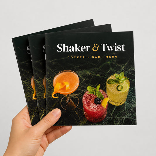 Custom 6 x 6 square saddle-stitched booklets held in hand