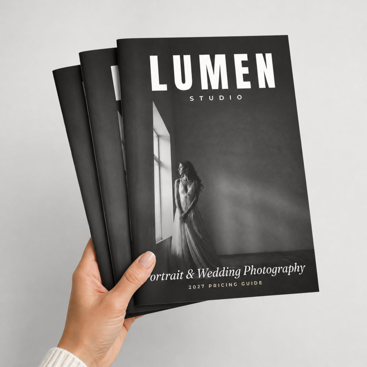 Custom 8 x 10 saddle-stitched booklets held in hand
