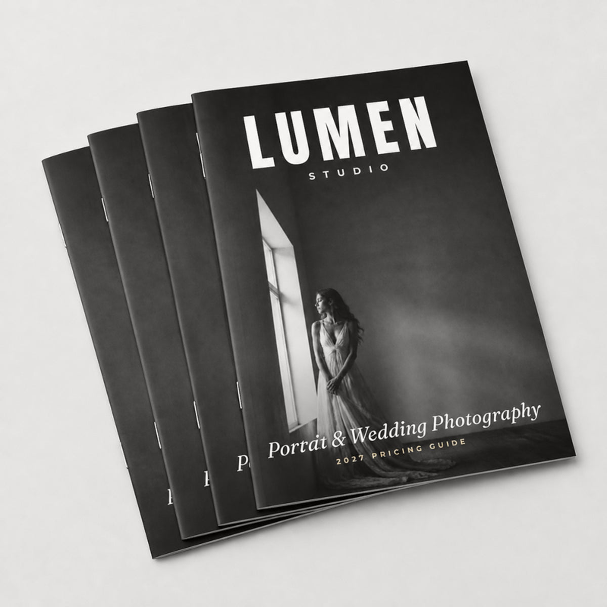 Stack of saddle-stitched 8 x 10 booklets showing the wire staples